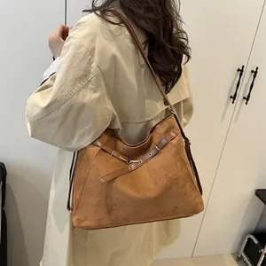 Brown suede hobo bag with adjustable strap and gold metal rings for women daily commute
