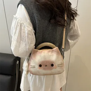 Cute plush cat-shaped shoulder bag in beige and brown with soft fur pompom charm