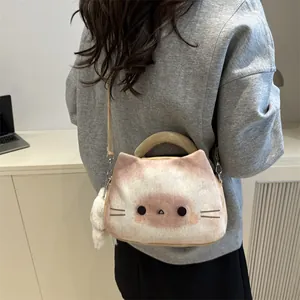 Cute plush cat-shaped crossbody bag with soft ears and a pompom charm in light beige