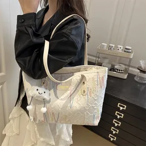 Quilted white canvas tote bag with colorful wave embroidery and a plush cloud charm