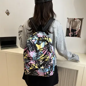 Student backpack with colorful abstract graffiti patterns shown in a lifestyle indoor setting