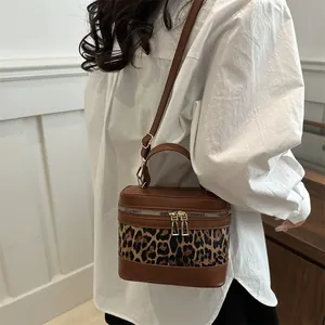 Vintage leopard print box bag with brown leather accents and gold double zippers