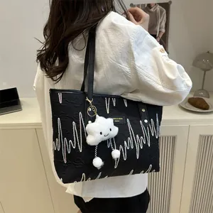 Black canvas tote bag with colorful wave embroidery and star plush keychain pendant