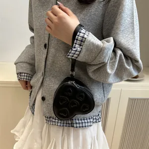 Mini heart-shaped black PU leather crossbody bag with wristlet strap and zipper detail