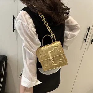 Chic gold metallic handbag with wavy embossing and chunky chain strap for women