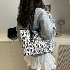 Vintage letter print tote bag with black and white monogram and golden pendant charm