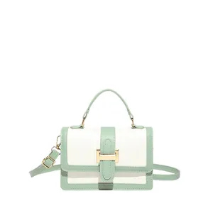 Contrast color mint green and white small square bag with crocodile pattern and gold buckle
