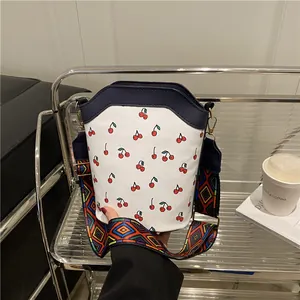 Women Fashion Cherry Print Bucket Bag PU Leather Crossbody Bag With Bohemian Geometric Woven Wide Strap Handbag Daily Bag