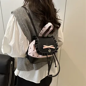 Sac à dos seau rose matelassé style ballet avec nœuds noirs et pendentif cœur