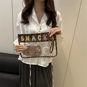 Transparent leopard print makeup bag with SNACKS embroidery and wristlet strap