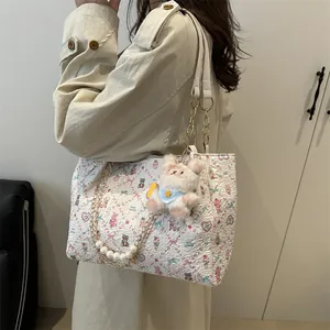 White floral embroidery tote bag with pearl chain strap and cute bunny plush charm
