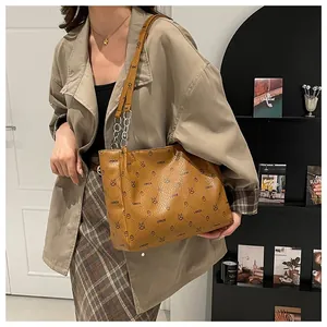 Brown faux leather tote bag with letter prints and silver chain strap for women