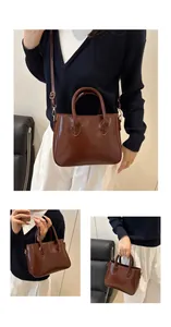 Detail view of glossy dark brown leather vintage crossbody bag with gold hardware