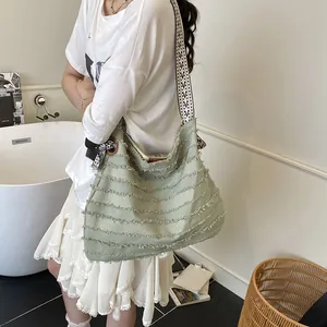 Minimalist light green canvas tote bag with fringe details and woven strap for women