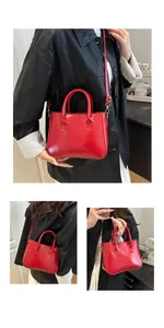 Detail of red glossy patent leather handbag with gold metal hooks and slim strap