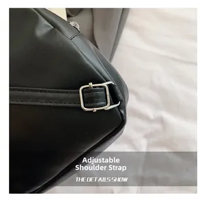 Detail of adjustable black PU leather shoulder strap with silver square buckle and neat stitching
