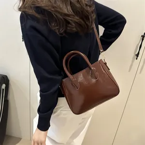 Retro dark brown glossy leather small tote bag with round handles and gold hardware