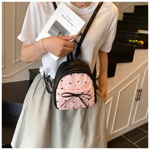 Pink pleated mini backpack with black bow patterns and elegant side bow detail