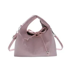 Pink minimalist single shoulder bag with drawstring bow and metal bead details