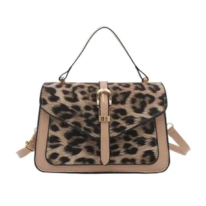 Leopard print crossbody handbag with beige faux leather trim and golden metal clasp