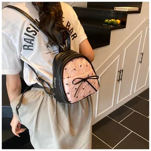 Mini backpack for women featuring a black and pink pleated design with cute bow details
