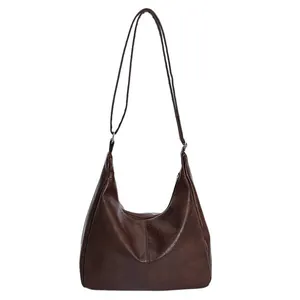 Minimalist dark brown PU leather crescent tote bag for women featuring a sleek shoulder strap