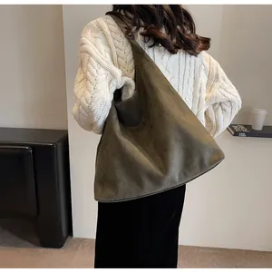Detailed view of dark olive suede hobo bag showing its large capacity and soft texture