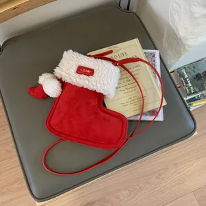 Vintage red suede Christmas stocking crossbody bag with plush trim and pompom strap