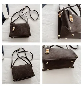 Detailweergave van koffiebruine crossbodytas met goudkleurig slot en metalen klinknagels