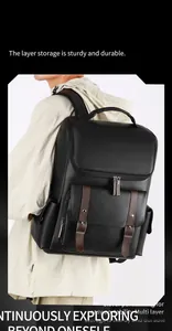 Close-up of vintage black PU leather backpack with brown buckle straps and USB charging port
