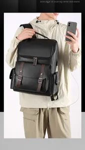 Detail of the vintage PU leather backpack showing the external USB charging port in use