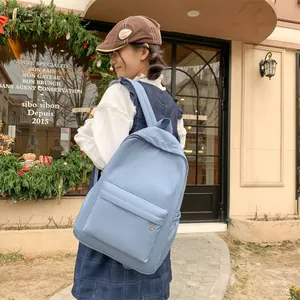 Detail eines hellblauen wasserdichten Nylon-Rucksacks mit Vordertasche und Flaschenhalterung