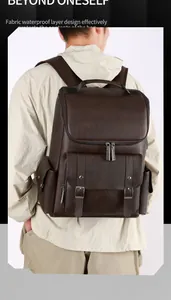 Close-up of brown vintage PU leather backpack showing waterproof fabric and buckle detail