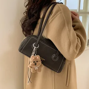 Retro dark brown leather shoulder bag with contrast stitching and teddy bear charm