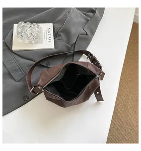 Detailed interior of vintage brown faux leather shoulder bag with spacious compartment