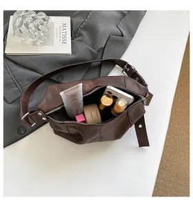 Detailed view of the dark brown pleated shoulder bag interior showing spacious capacity