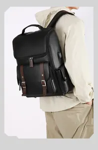 Detail view of the vintage PU leather backpack with USB port and brown buckle straps