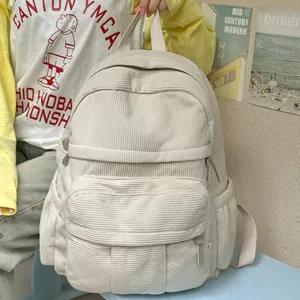 Nahaufnahme der beigen Cord-Rucksack-Struktur mit Hauptreißverschluss und Fronttasche