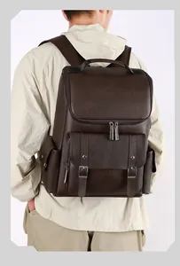 British vintage dark brown PU leather backpack shown on model in an outdoor setting