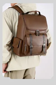 Detail of vintage brown PU leather backpack showing side view and metallic belt buckles