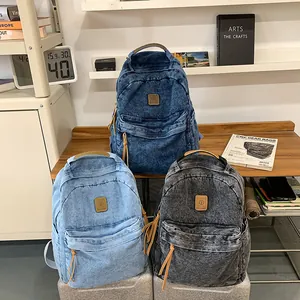 Three vintage denim backpacks in navy, light blue, and black for students and daily travel