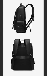 Detail showing the USB charging port and breathable mesh back padding on a black leather backpack