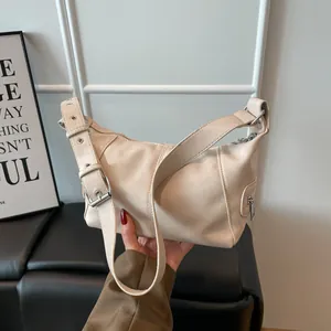 Chic off-white faux leather hobo bag with adjustable silver buckle strap and litchi texture