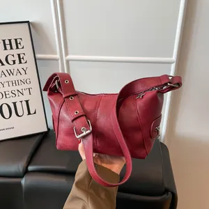 Retro burgundy leather shoulder bag with wide strap and large silver metal buckle