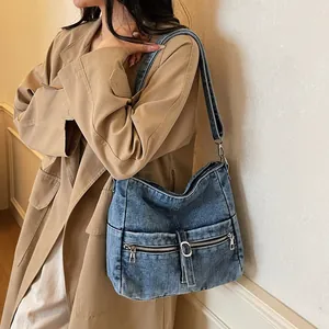 Retro blue washed denim crossbody bag featuring double zipper pockets and adjustable strap