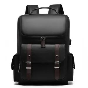 Vintage black faux leather backpack with brown belt buckles and USB charging port