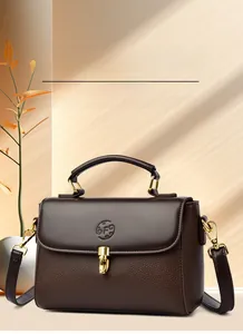 Detailed view of dark brown lychee grain leather with elegant gold buckle and logo