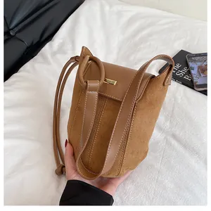 Macro detail of brown leather stitching and golden buckle on minimalist shoulder bag