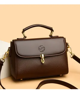 Detail view of leather crossbody bag with letter F embossing and gold metal lock