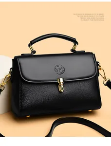 Close-up of black leather doctor bag featuring gold metal lock and embossed F logo